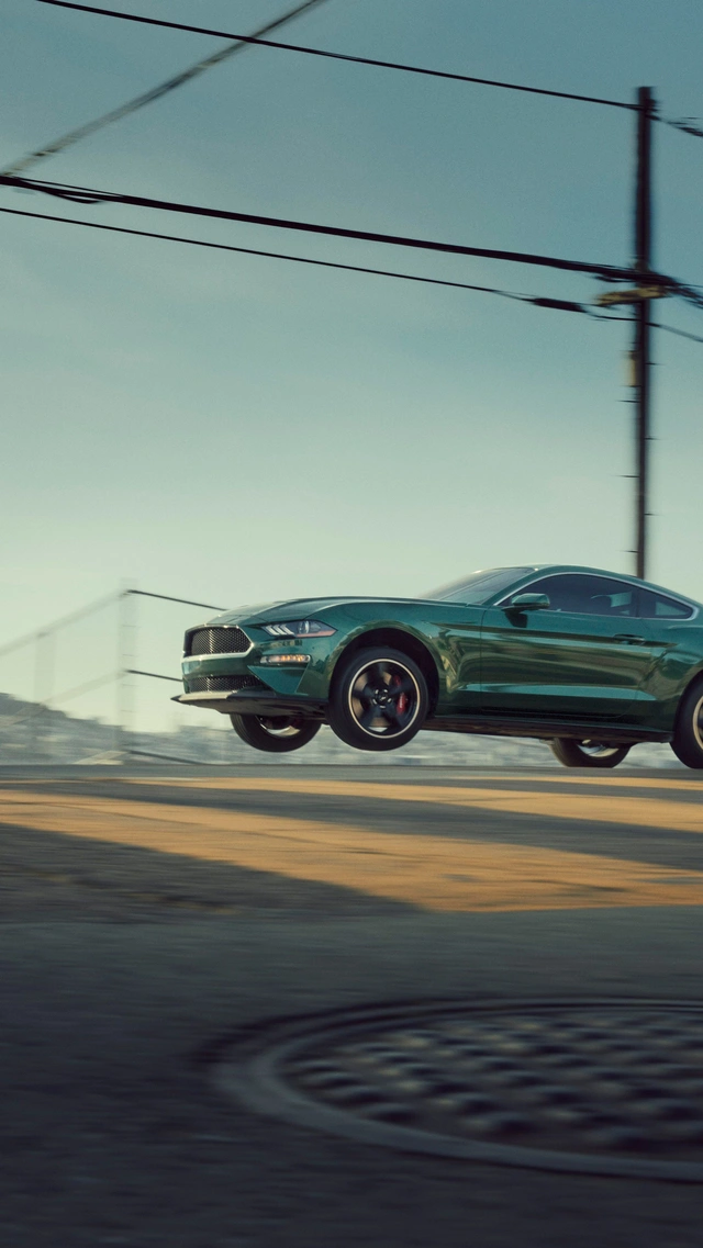 Green Sports Car in Mid-Air